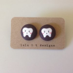 Tooth fabric covered button earrings pair